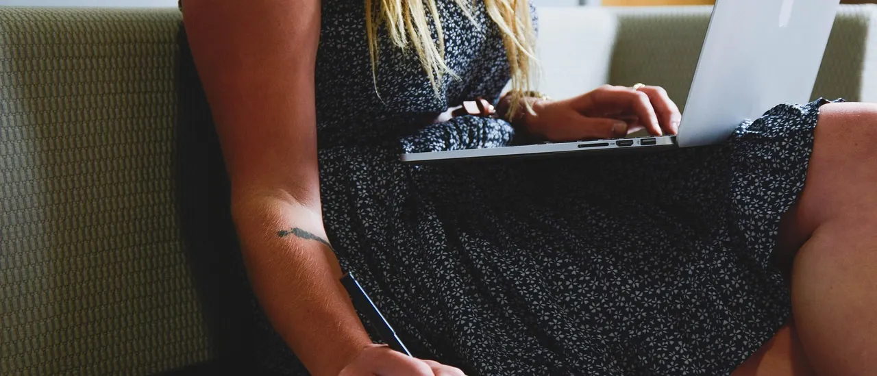 A self-employed woman working on her laptop at home
